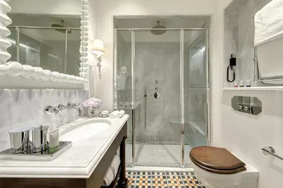 a bathroom with a shower and a sink and a toilet at Rocco Forte Villa Igiea in Palermo