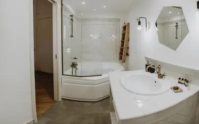 a white bathroom with a sink and a bath tub at Maravigghia Palermo Rooms in Palermo