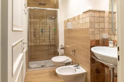 a bathroom with a toilet and a sink and a shower at Federico 70 Giada Economy in Palermo