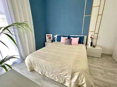 a bedroom with a large bed with pink pillows at Charmrooms in Castellammare del Golfo