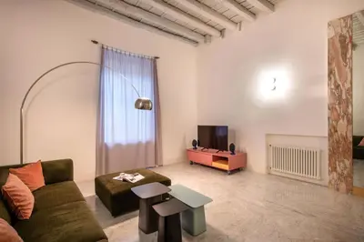 a living room with a couch and a table at Sartoria Cavour - Modern Sicilian Elegance in a Former Tailor Shop in Palermo