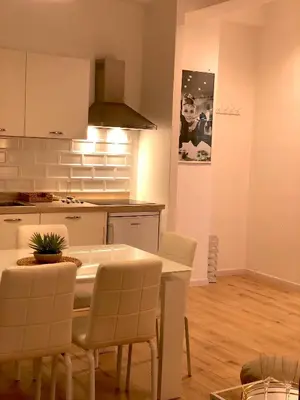 a kitchen and dining room with a table and chairs at Residence D'azeglio in Palermo