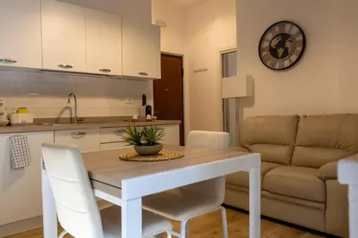 a kitchen and living room with a table and chairs at Residence D'azeglio in Palermo