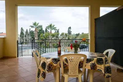 a dining room with a table and chairs on a balcony at RESIDENCE FEDERICA in Castellammare del Golfo