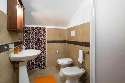 a bathroom with a toilet and a sink at RESIDENCE FEDERICA in Castellammare del Golfo