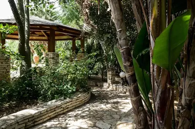 a path in a garden with a wooden pavilion at RESIDENCE FEDERICA in Castellammare del Golfo
