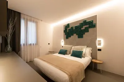 a bedroom with a large bed with green pillows at Civic03 B&B in Terrasini