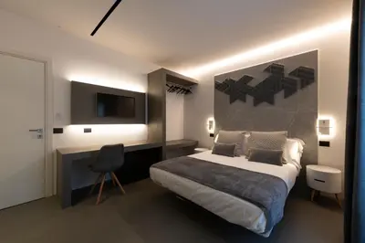 a bedroom with a bed and a desk and a television at Civic03 B&B in Terrasini
