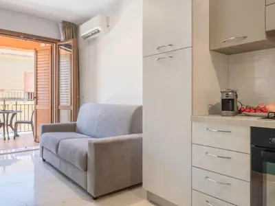 a living room with a couch and a kitchen at Apartment Palermo by Interhome in Balestrate