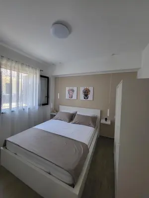 a bedroom with a large white bed with a window at A-marè - CasaVacanza in Trappeto