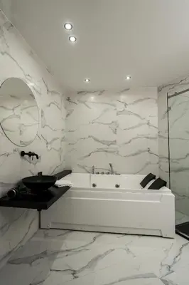 a white bathroom with a tub and a sink at Marmur Suite in Palermo