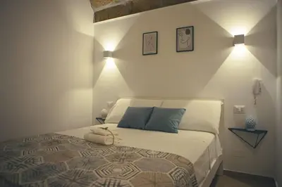 a bedroom with a bed with two pillows on it at Agorà Home in Terrasini