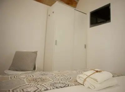 a bedroom with a bed with towels on it at Agorà Home in Terrasini