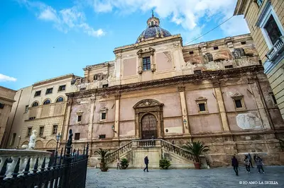 an old building with people walking in front of it at Casetta Holiday Meli in Palermo