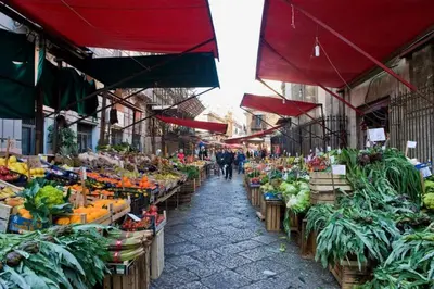 an outdoor market with fruits and vegetables on display at Casetta Holiday Meli in Palermo