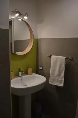 a bathroom with a sink and a mirror at Arco Cutò casa vacanze in Palermo