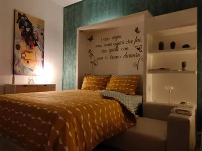 a bedroom with a bed and some writing on the wall at Arco Cutò casa vacanze in Palermo