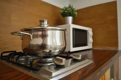 a pot on top of a stove with a microwave at Arco Cutò casa vacanze in Palermo