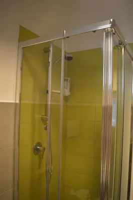 a shower with a glass door in a bathroom at Arco Cutò casa vacanze in Palermo
