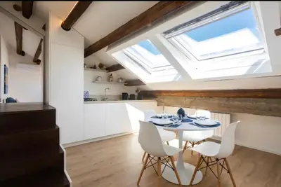 a kitchen and dining room with a table and chairs at Kalsa Skyhome in Palermo