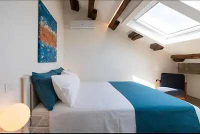 a bedroom with a bed and a skylight at Kalsa Skyhome in Palermo