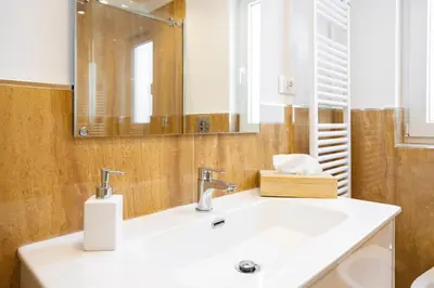 a bathroom with a sink and a mirror at Cube 67 - Garden in Palermo