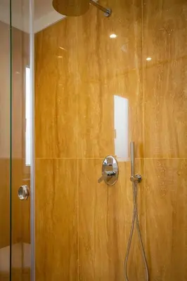 a shower with a glass door in a bathroom at Cube 67 - Garden in Palermo