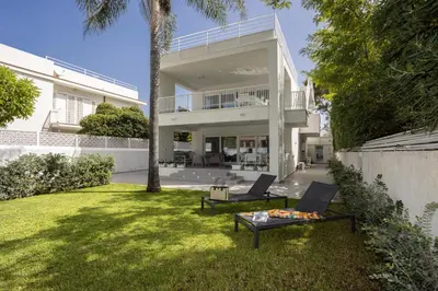 a house with two chairs and a table in the yard at Cube 67 - Garden in Palermo