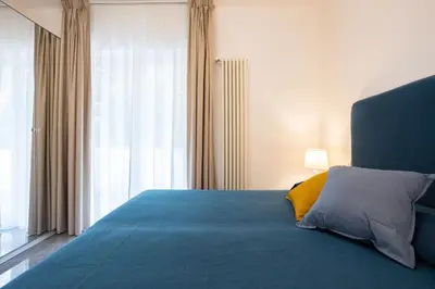 a bedroom with a blue bed with a yellow pillow at Cube 67 - Terrace in Palermo