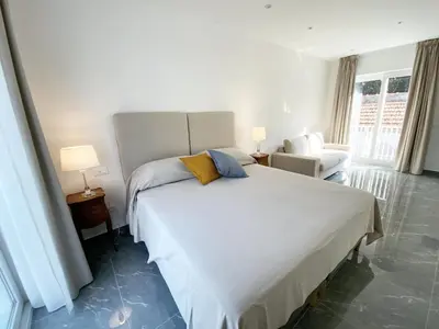 a bedroom with a large white bed and a chair at Cube 67 - Terrace in Palermo