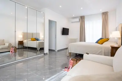 a hotel room with two beds and a mirror at Cube 67 - Terrace in Palermo