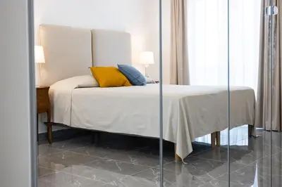 a bedroom with a bed with yellow pillows on it at Cube 67 - Villa in Palermo