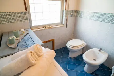 a bathroom with a tub and a toilet and a sink at A casa di Mara in Mondello