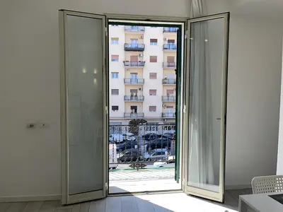 an open glass door with a view of a building at Le dimore Luxury Rooms in Palermo