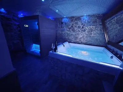 a large bath tub in a room with blue lights at Caveau in Palermo