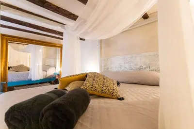 a bedroom with a large bed with a leopard pillows on it at Caveau in Palermo