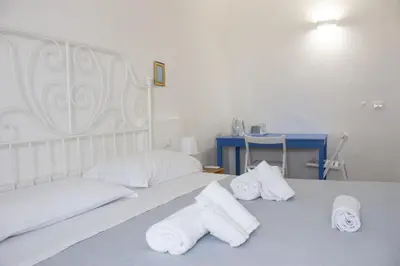 a bedroom with two beds with towels on it at Terrasini 2000 Home Holidays in Terrasini