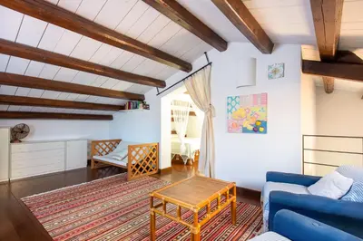 a living room with a blue couch and a table at Villetta Rosamarina by Wonderful Italy in Cefalù