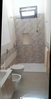 a bathroom with a toilet and a sink and a shower at A Casa Ri Angela in San Vito lo Capo