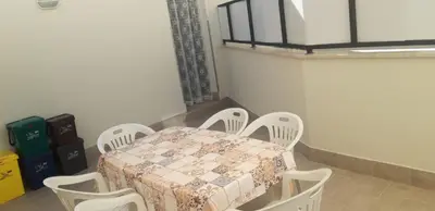 a dining room with a table and white chairs at A Casa Ri Angela in San Vito lo Capo