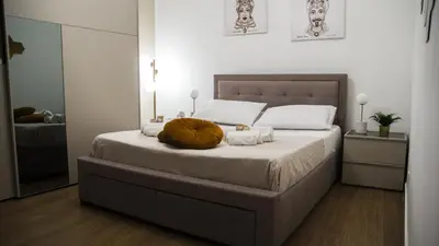 a bedroom with a large bed with a pumpkin on it at Le Maioliche Apartment in Palermo