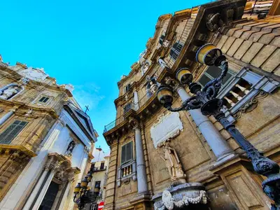 a tall building with a street light in front of it at Le Maioliche Apartment in Palermo