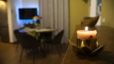 a candle sitting on a table in a living room at Le Maioliche Apartment in Palermo