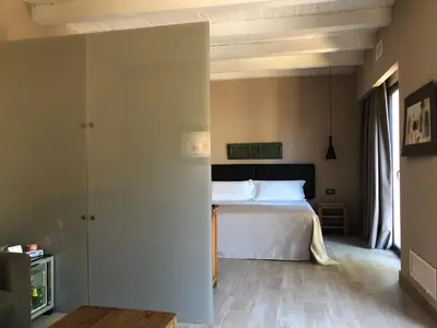 a bedroom with a bed and a room with a tv at Araja Villa&Suite by Geocharme in San Vito lo Capo
