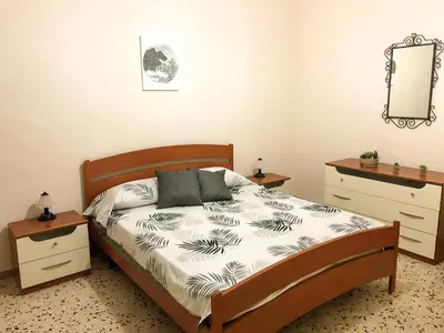 a bedroom with a bed and a dresser and a mirror at Casa Conchiglia in San Vito lo Capo