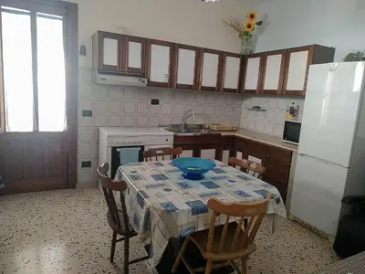 a kitchen with a table with a blue bowl on it at Casa Conchiglia in San Vito lo Capo