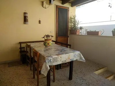 a table with a vase on it in a room at Casa Conchiglia in San Vito lo Capo