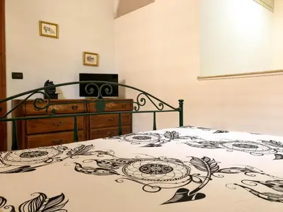 a bedroom with a bed with a black and white blanket at Casa Conchiglia in San Vito lo Capo