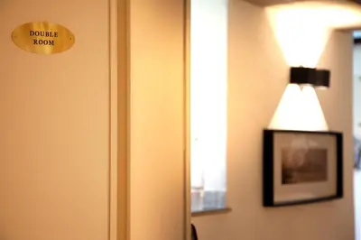 a light on a door with a sign that reads double room at Palermo alla Gancia Room in Palermo