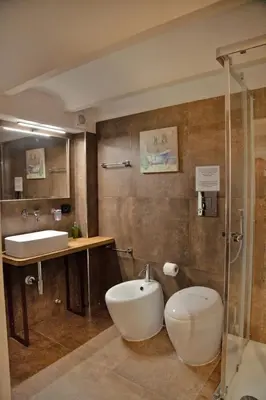 a bathroom with a tub and a sink and a toilet at Palermo alla Gancia Room in Palermo